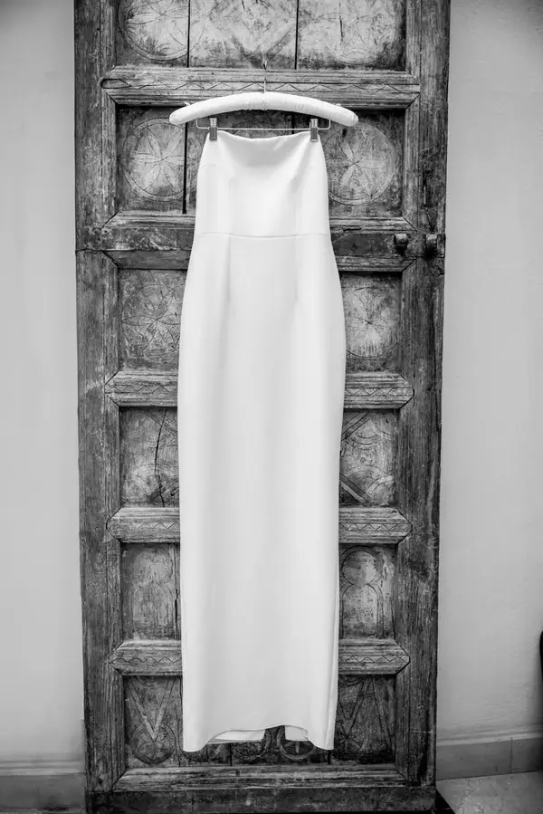 Wedding dress hanging on antique Moroccan door black and white - photographer wedding