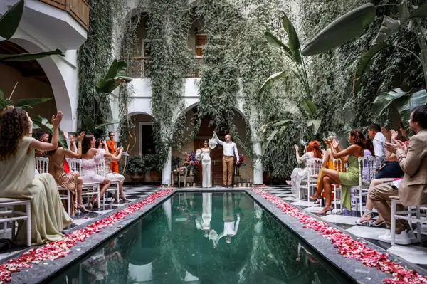Wedding ceremony at riad pool with rose petals - wedding photographer marrakech