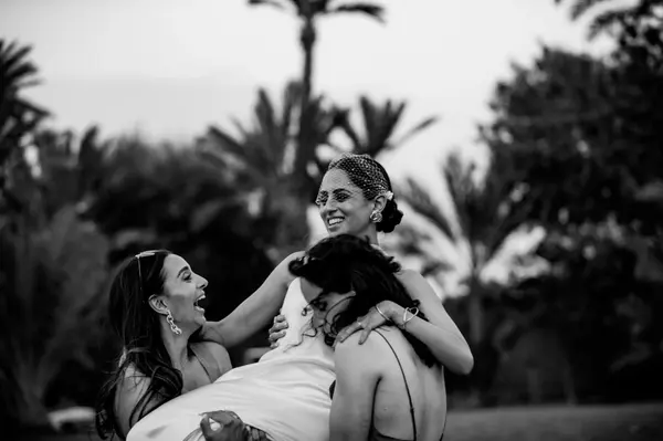 Bridesmaids laughing candid moment black and white - professional photographer marrakech